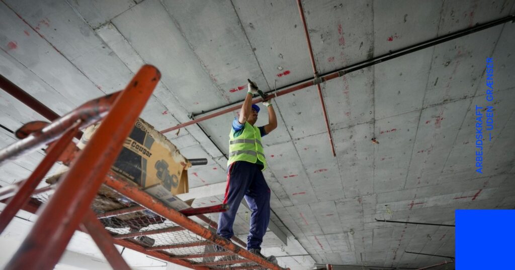 Arbejdende håndværker i gang med tag for at symbolisere entreprenørarbejde