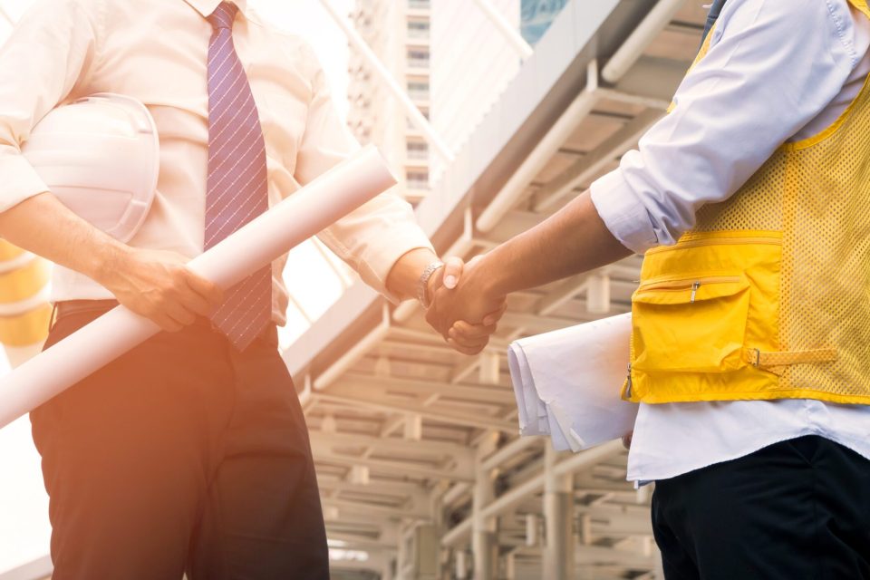 Engineers,Shaking,Hands,At,Construction,Site,For,Architectural,Project,,Holding